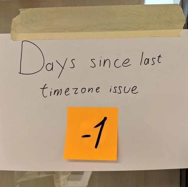 paper sheet with “days since last timezone issue” written on it. theres a post it stating “-1”